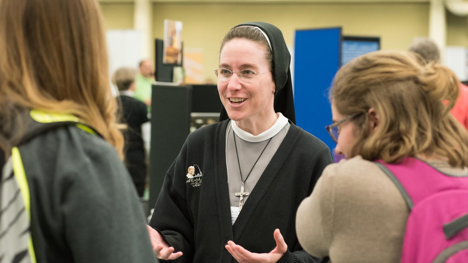 Sister talking to students